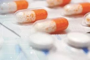 close up of orange and clear medicine capsules and white pills