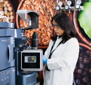 female scientist working with equipment against pictures of natural resources