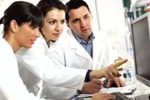 three scientists in a research lab