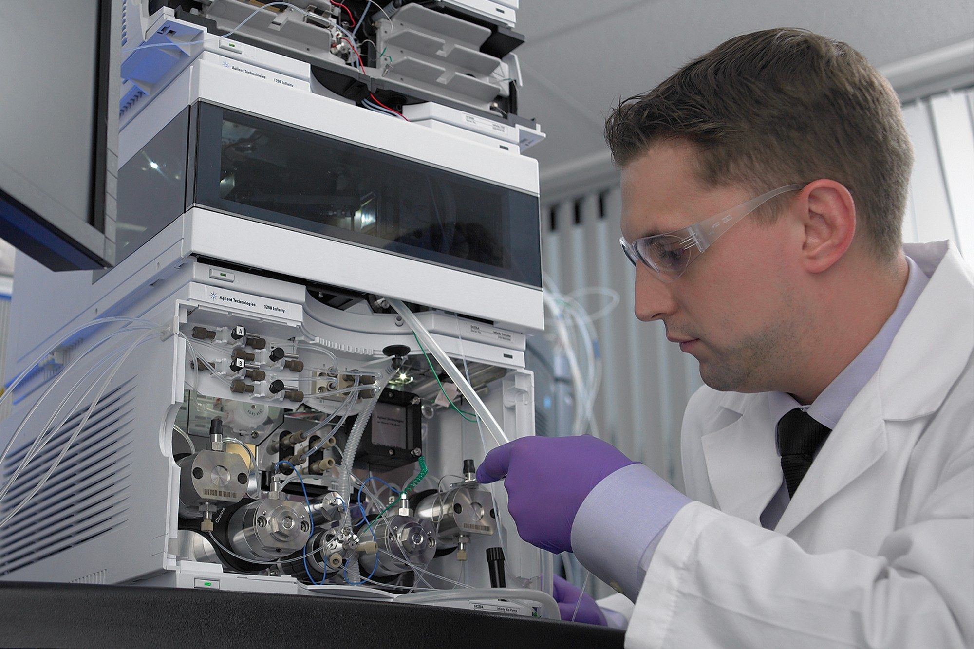 Male scientist working on Agilent system ensuring compliance