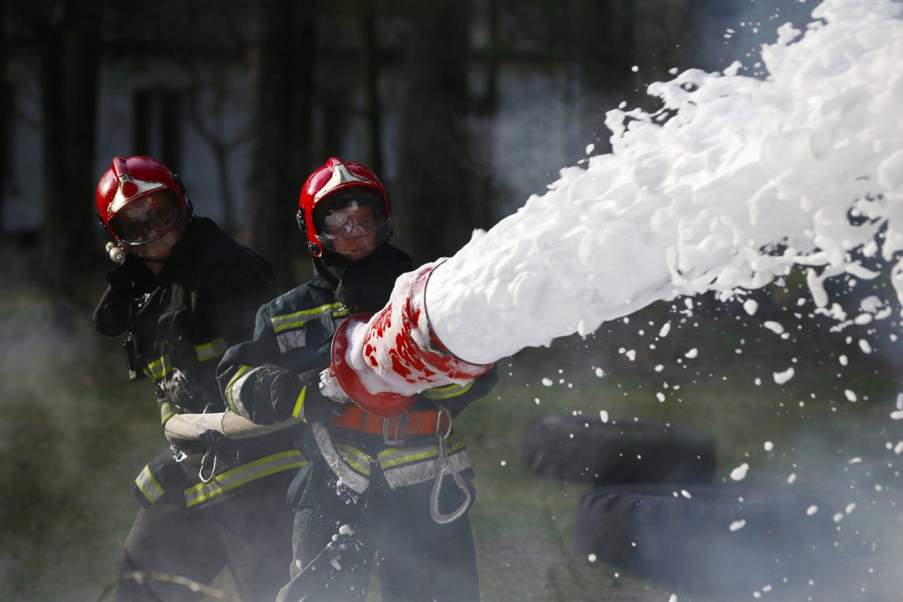 Firefighters battling flames with AFFF