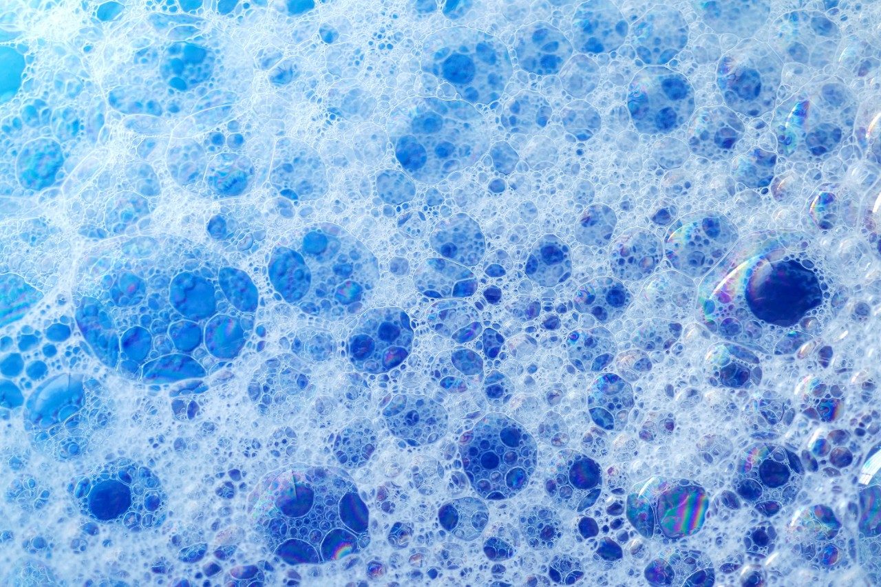 Soap bubbles on blue liquid