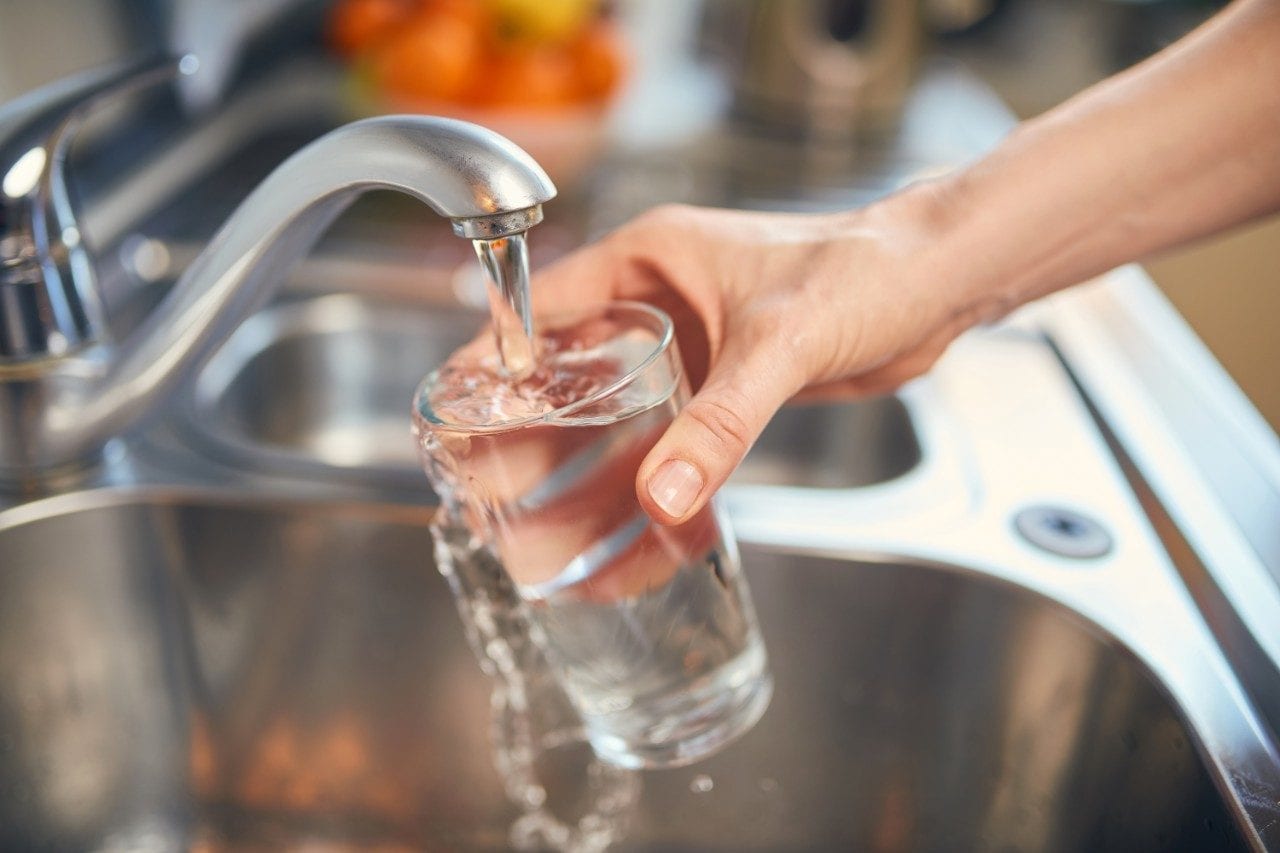 Pouring tap water into a glass