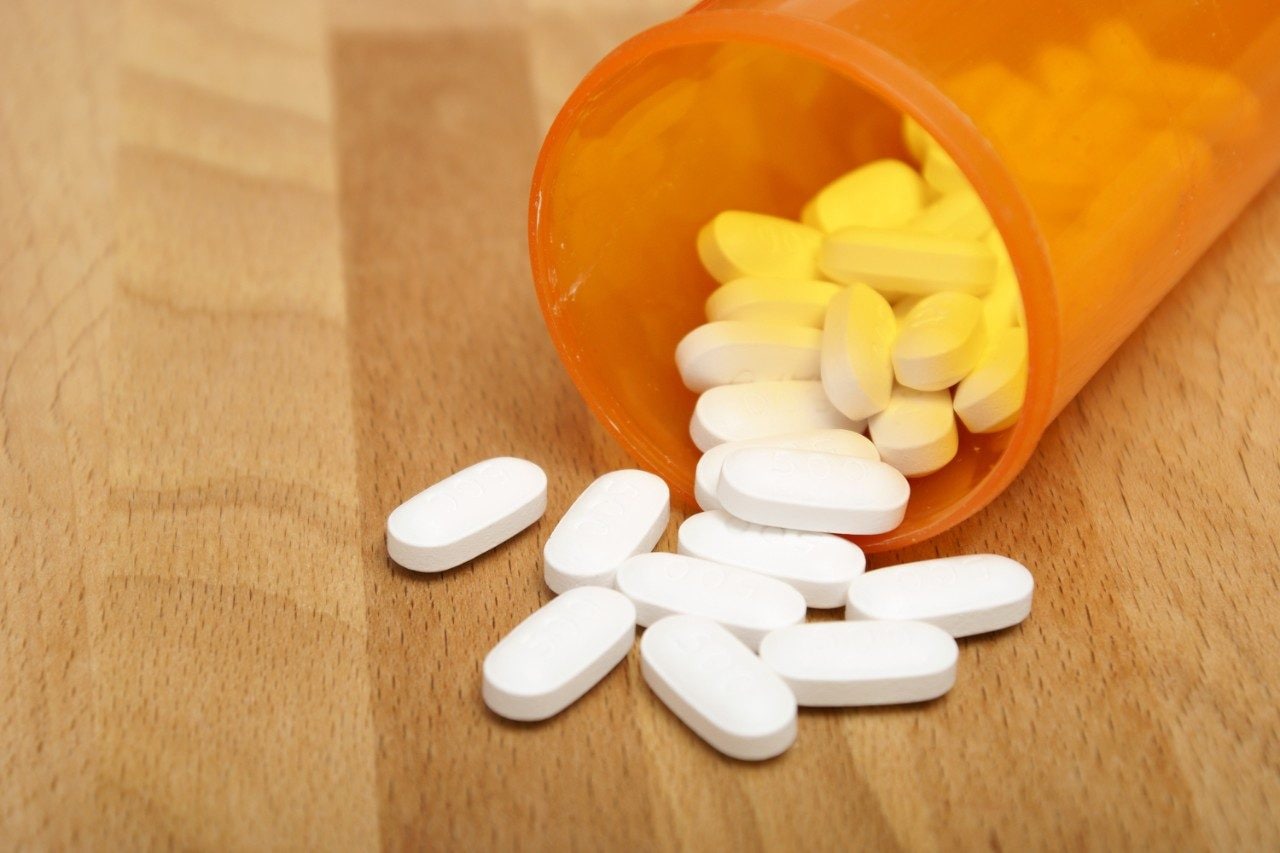 Acetaminophen tablets spilling out of bottle