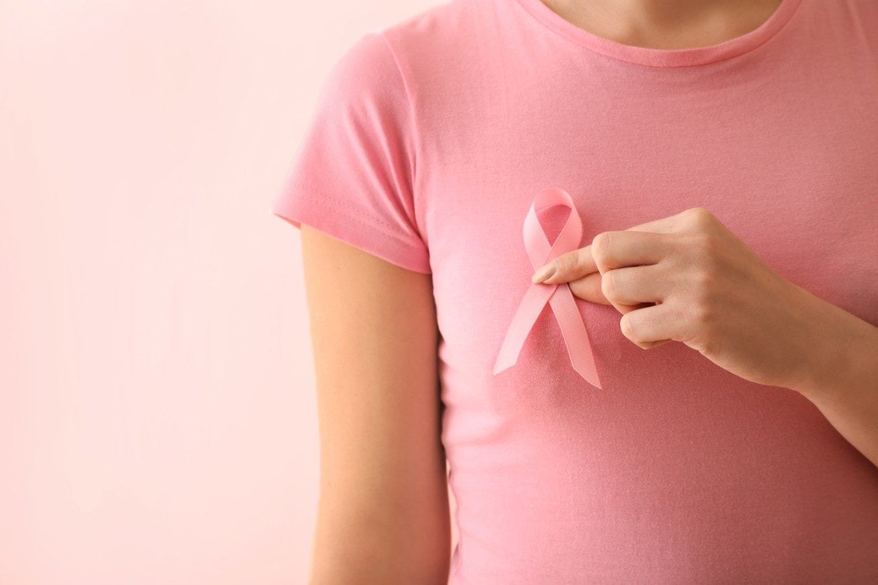 Woman with pink ribbon, breast cancer awareness