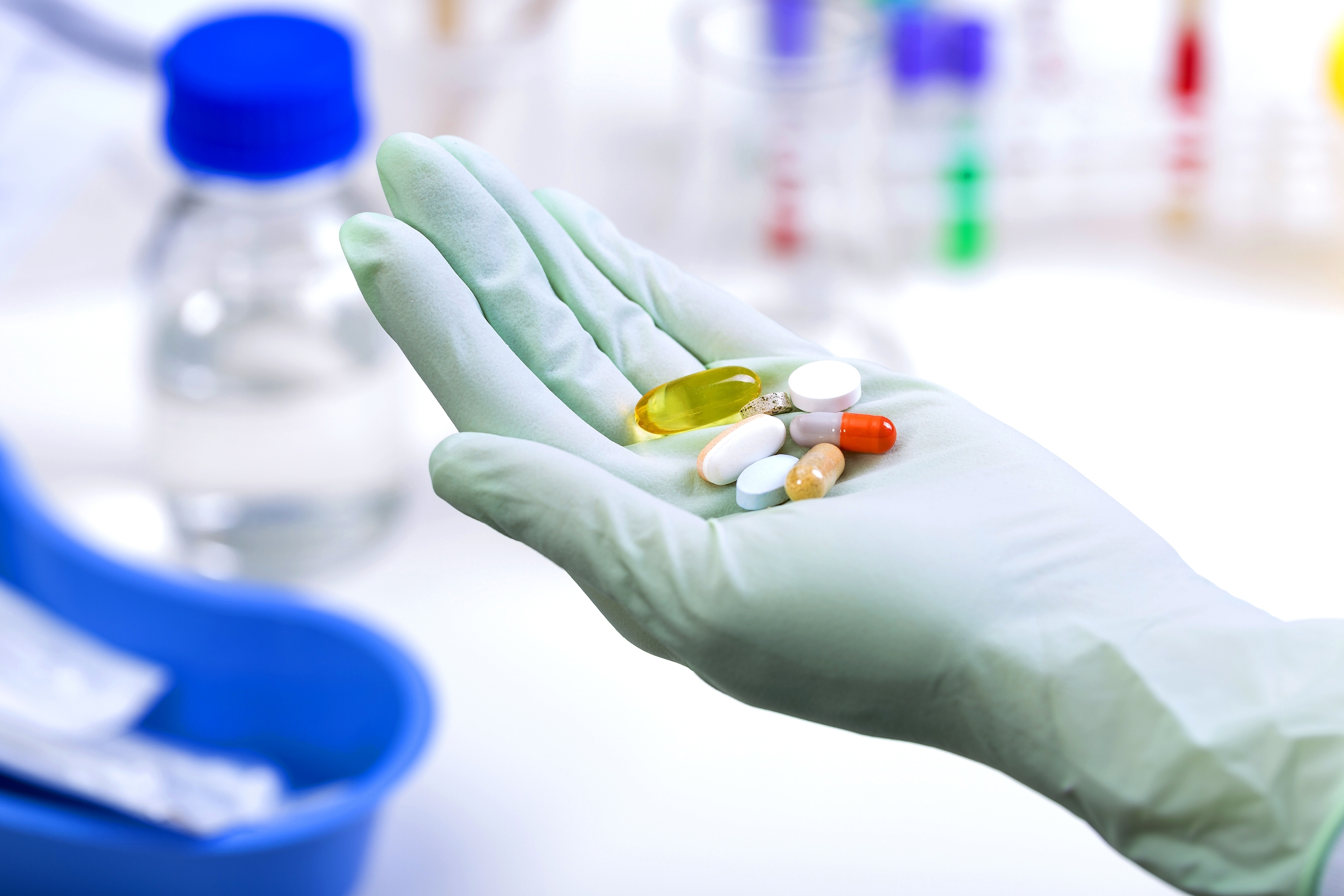 Medical pills in a hand of laboratory worker