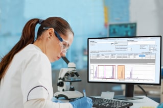 Scientist at computer with ChromScope data displayed on screen