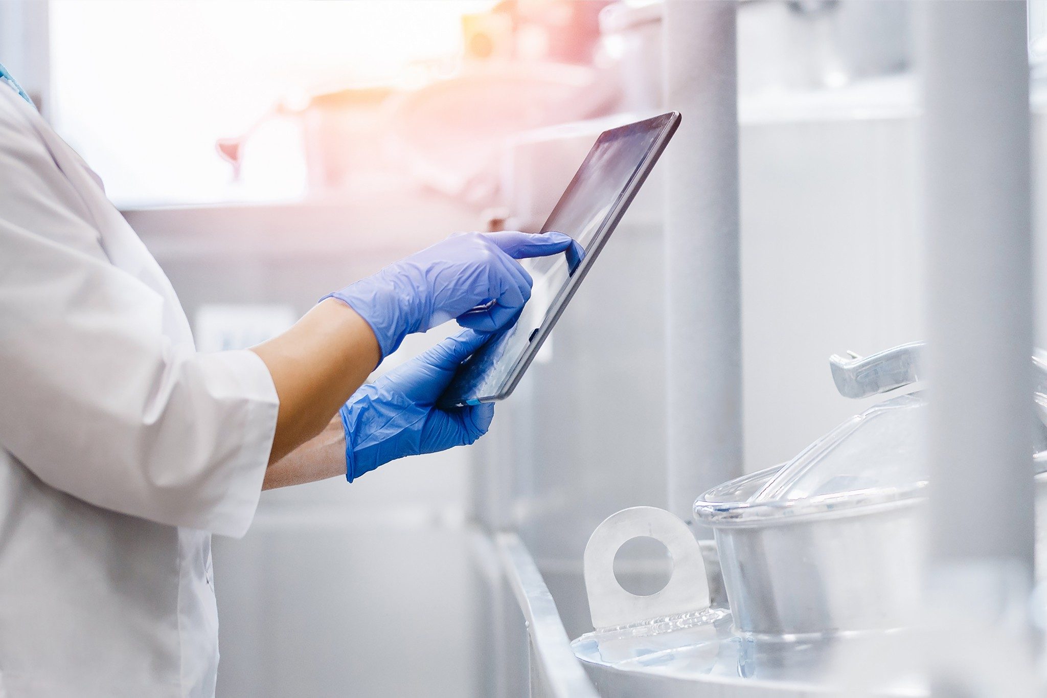 Lab tech close up on hands with a tablet