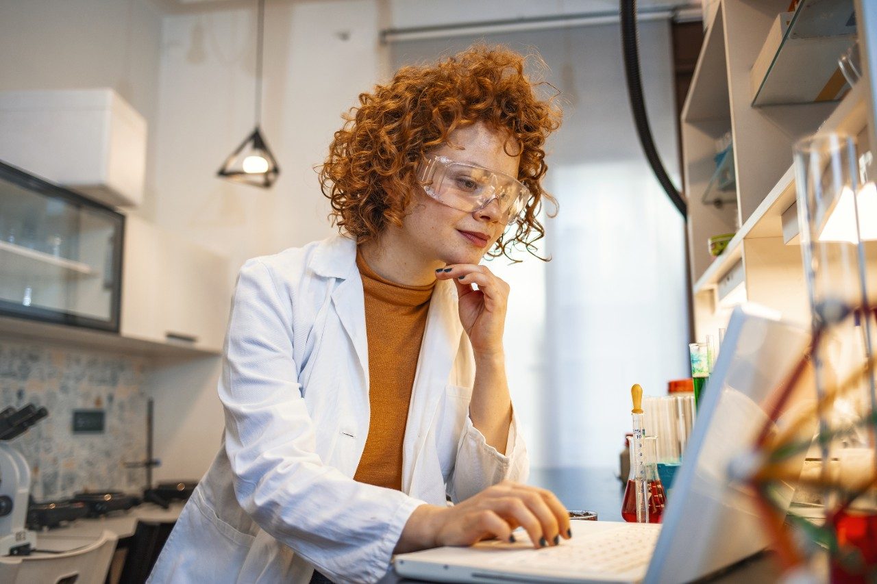 Scientist working on laptop in laboratory