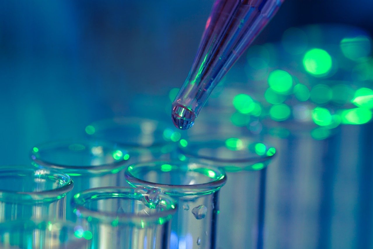 Pipette adding fluid to one of several test tubes