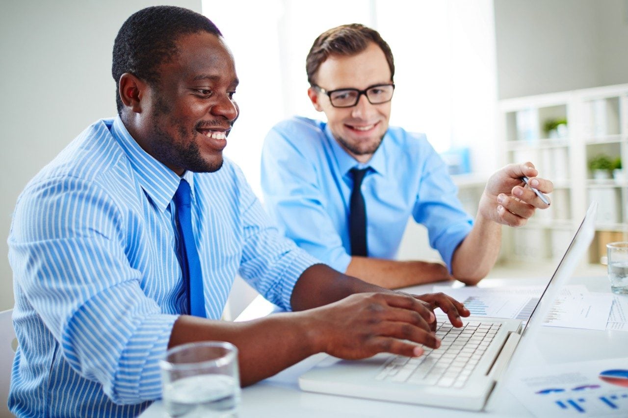 Male colleagues working together on laptop