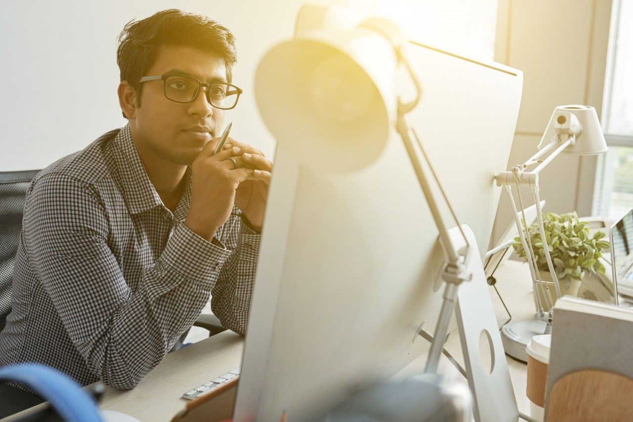 Young male Indian entrepreneur working in office